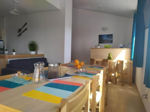 a dining room with a table and some chairs at Le cheiron in Coursegoules