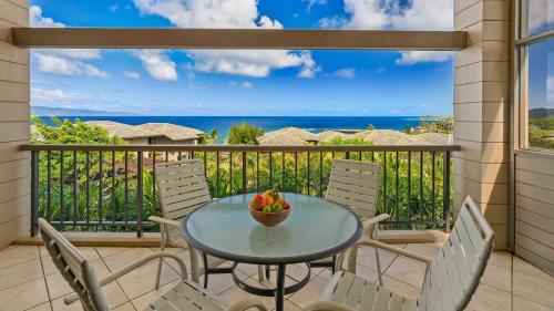 a table with a bowl of fruit on a balcony at Kapalua Ridge Villa 1112 in Kapalua