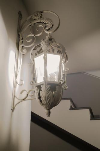 a chandelier on the stairs in a house at La Dimora degli ulivi in SantʼAlfio