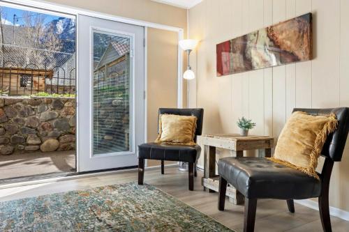 two chairs and a table in a room with a window at 325 6th Ave Unit A in Ouray