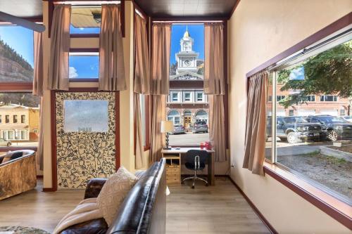 a living room with a couch and a large window at 325 6th Ave Unit A in Ouray