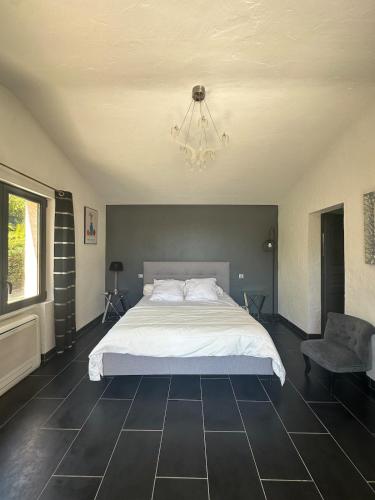 - une chambre avec un grand lit blanc et un lustre dans l'établissement Vivre Sainte-Maxime à pieds, à Sainte-Maxime