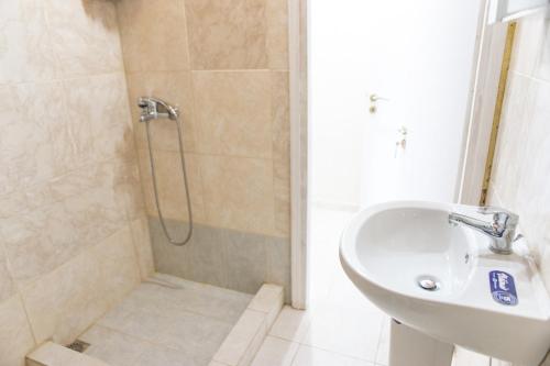a bathroom with a sink and a shower at calmia in Lefkada Town