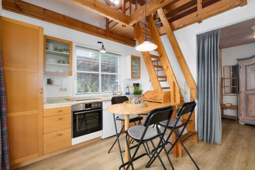 a kitchen with a wooden table and chairs at Lütt Drosselhörn 1 in Laboe