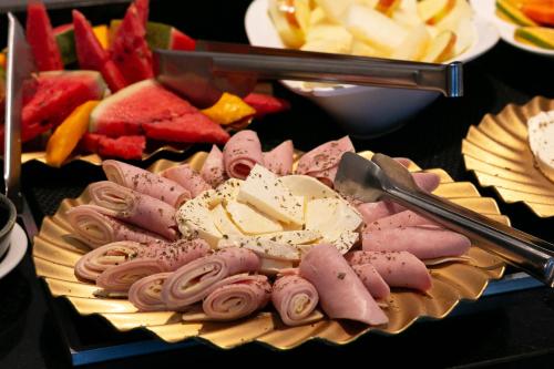 a plate of food with desserts on a table at EZ Moema Hotel in Sao Paulo