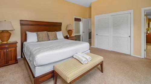 a bedroom with a large bed and a wooden headboard at Kapalua Ridge Villa 1721 in Kapalua