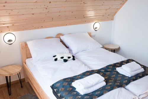 a bedroom with a bed with a stuffed animal on it at Zacisze Deluxe - Apartamenty in Krościenko