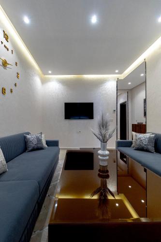 a living room with a blue couch and a table at Medina residency in Tangier