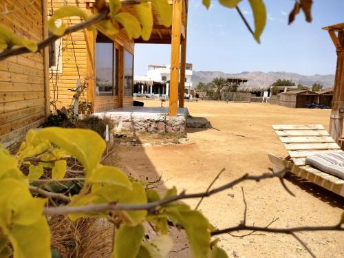 a porch of a house with a dirt yard at Mountain Sinai camp in Wāsiţ