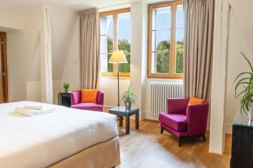 Postel nebo postele na pokoji v ubytování Le Manoir du Golf