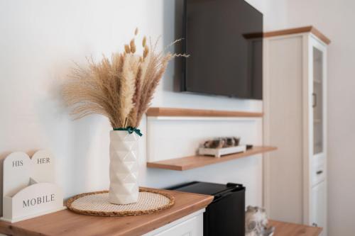 a vase with grass in it sitting on a kitchen counter at Ferienhaus Purgar in Kammern im Liesingtal