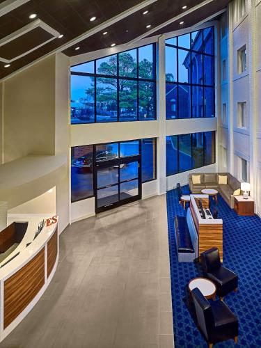 a lobby of a building with large windows at Sonesta Simply Suites Memphis East Poplar Pike in Memphis