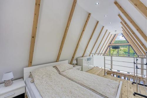 a bedroom with a bed and a large window at UNA RESORT in Bosanska Krupa