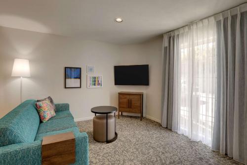 a living room with a couch and a tv at Sonesta ES Suites Sunnyvale in Sunnyvale