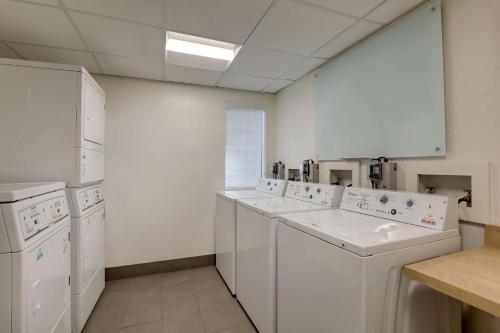 a large white laundry room with white appliances at Sonesta ES Suites Sunnyvale in Sunnyvale