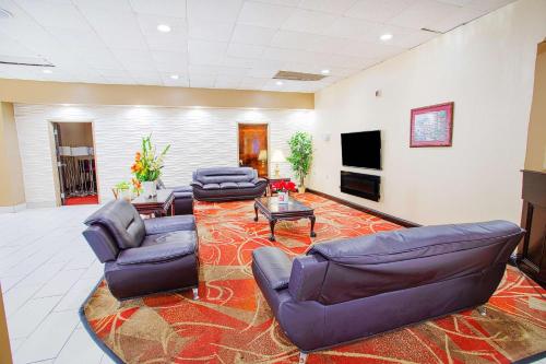 a large living room with couches and a tv at Americas Best Value Inn Winston-Salem in Winston-Salem