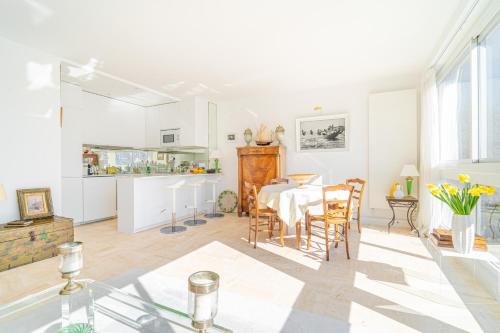 une salle à manger et une cuisine avec une table et des chaises dans l'établissement Lovely apartment with view, à Paris