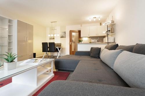 a living room with a couch and a table at Waldstraße 4 Waldkoje in Kellenhusen