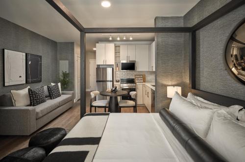 a bedroom with a bed and a living room at Luxury Apartments by Hyatus Center City in Philadelphia