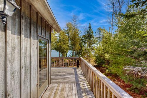 a wooden walkway leading to a house with glass doors at Rogers Rock in Hancock