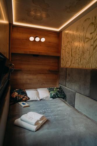 a bed in the back of a train at Water Hideout - Floating Villas in Wild Nature in Nowawieś Zbąska