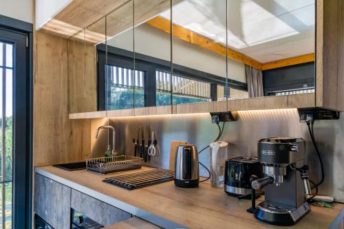 a kitchen with a coffee maker on a counter at Water Hideout - Floating Villas in Wild Nature in Nowawieś Zbąska