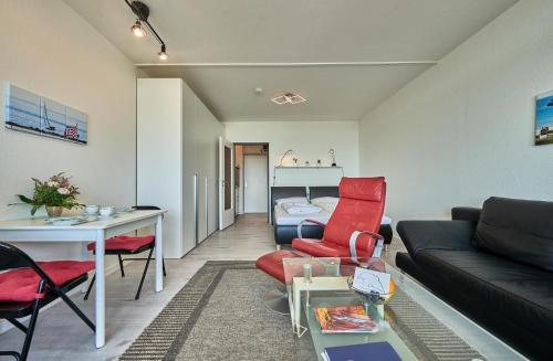 a living room with a couch and a table at Stranddistel 7 Ostseezauber in Burgtiefe auf Fehmarn 