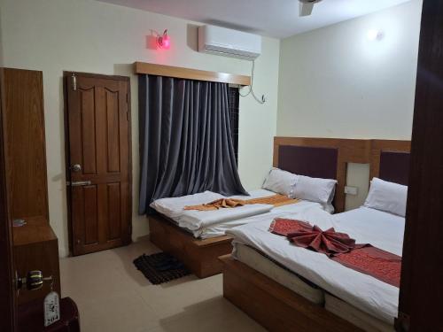 a bedroom with two beds and a window at Green Park Tea Resort Sreemangal in Sreemangal