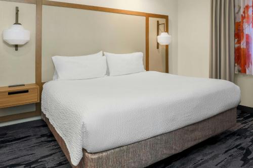 a large bed with white sheets and pillows in a room at Fairfield Inn and Suites by Marriott San Jose Airport in San Jose