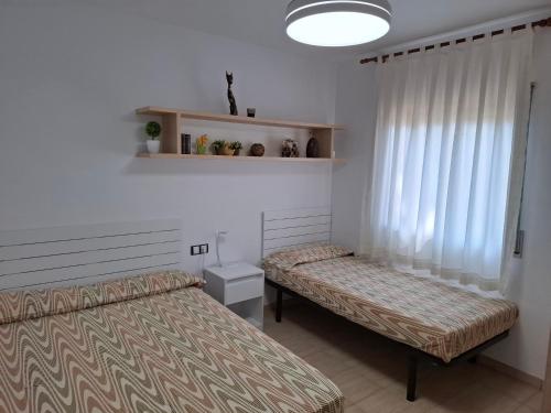 Postel nebo postele na pokoji v ubytování Cala del Pi