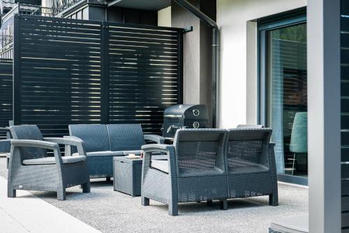 a group of chairs sitting next to a parking meter at Zacisze Deluxe - Apartamenty in Krościenko