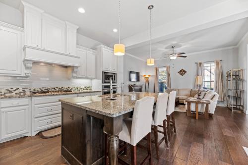 a kitchen with white cabinets and a table with chairs at Modern Allen Prairie Retreat in Allen