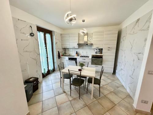 a kitchen and dining room with a table and chairs at Villa Tuscia apartments in Tuscania