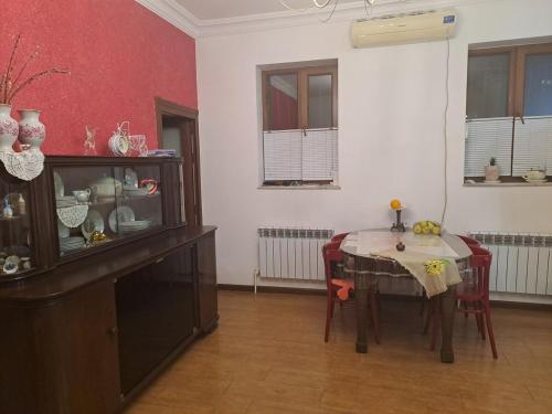a kitchen with a table and a red and white wall at Hill Station in Yerevan