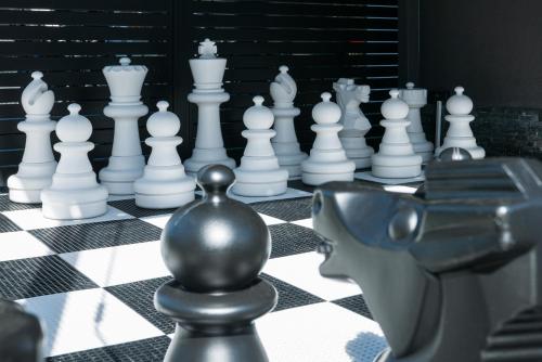 a chess board with white chess pieces on it at Zacisze Deluxe - Apartamenty in Krościenko
