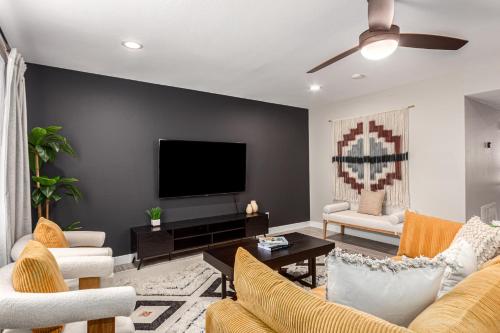a living room with a flat screen tv on a wall at 3BR Southwest Modern Haven - Old Town in Scottsdale