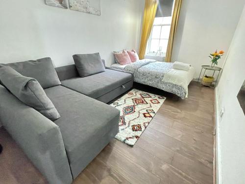 a living room with a couch and a table at Shoreditch Rooms Near Tower Bridge in London