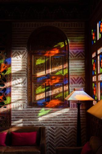 a room with a window with stained glass at Olinto, Atlas Mountain Retreat - adults only in Ouirgane