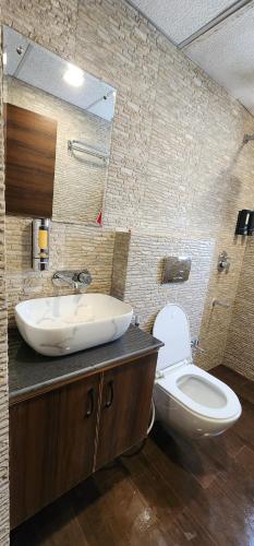 a bathroom with a sink and a toilet at The Butterfly Effect in Nilmatha