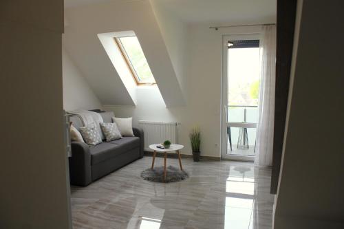 a living room with a couch and a table at Marót Apartman in Keszthely