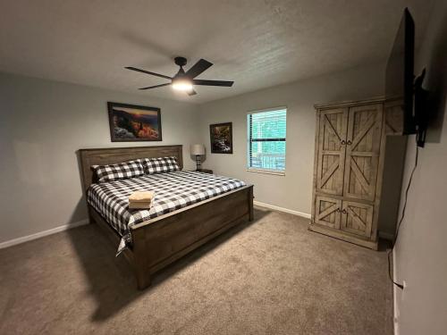 a bedroom with a bed and a ceiling fan at Kicback Shack - near Forge in Sevierville