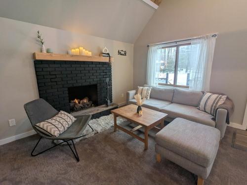 a living room with a couch and a fireplace at Walking Distance to the Beach Cabin with AC in Arrowhead Lake