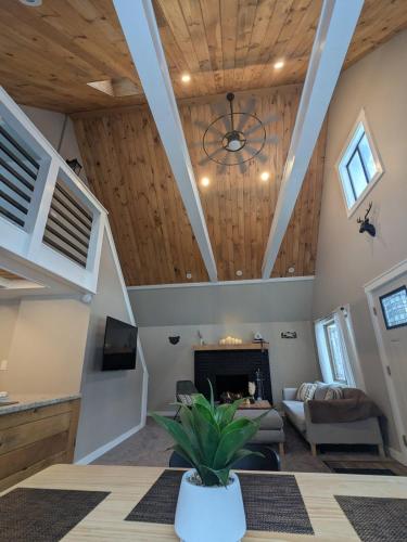 a living room with wooden ceilings and a fireplace at Walking Distance to the Beach Cabin with AC in Arrowhead Lake