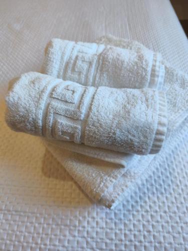 a pair of white towels sitting on top of a bed at Enebrales 423 in Punta Umbría