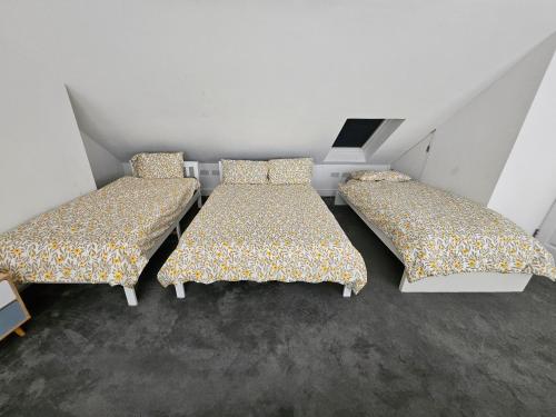 two beds in a small room with at SnoozeDen Westmead - Windsor Castle & Legoland in Windsor