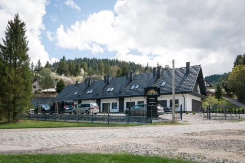 a building with cars parked in front of it at Zacisze Deluxe - Apartamenty in Krościenko