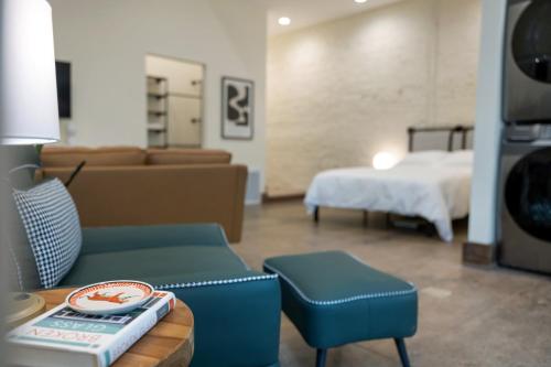 a living room with a couch and a bed at Modern Loft-Style Retreat Near Blenko Glass in Milton, WV in Hurricane