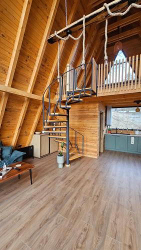 a room with a staircase in a wooden building at Old Nut Cabin in Teşila