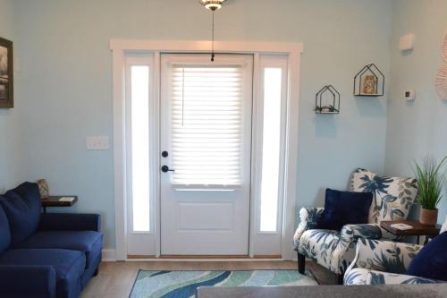 a living room with a blue couch and a door at 2BR Cozy Cottage Private Dock in Davis