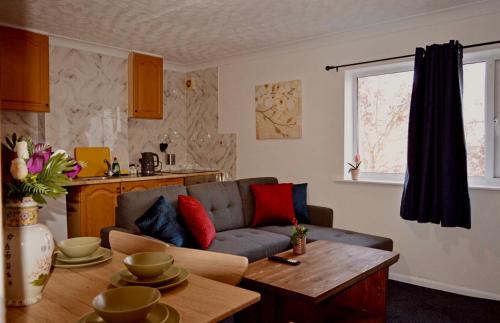 a living room with a couch and a table at Charming 2 bedrooms flat Skegness F11 in Skegness